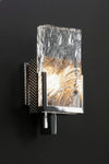 Decorative Chrome wall sconce with textured glass shade on a black background