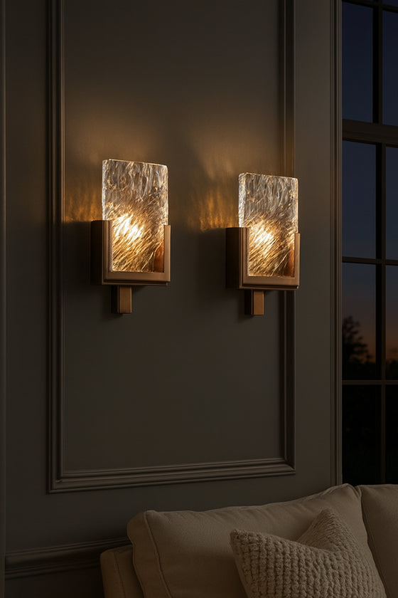Wall-mounted glass and metal lights with textured glass panels on a dark wall.