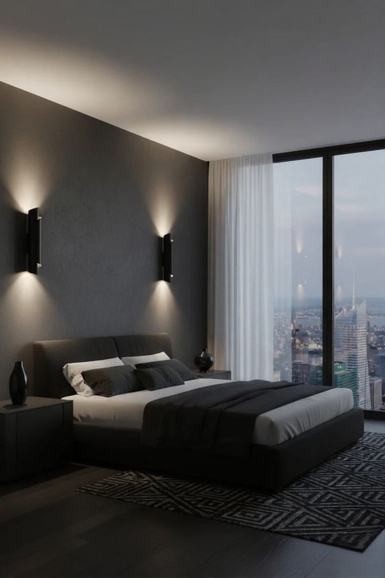 Modern bedroom with a large window view of a city skyline. Metal Black wall sconces LED.
