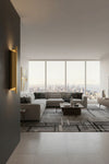 Modern living room with large windows offering a cityscape view. Satin Brass metal wall sconce. 