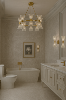  Luxurious bathroom with matching chandelier and sconces satin brass with clear glass, bathtub, and vanity.