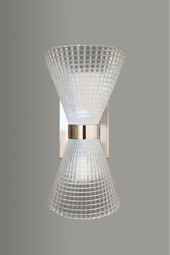 Wall-mounted light fixture with textured glass shade on a gray background. Polished Stainless Steel.