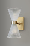 Wall-mounted light fixture with glass cone shade and satin brass base on a gray background