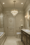 Luxurious bathroom with a satin brass and water glass chandelier, sink, and toilet.