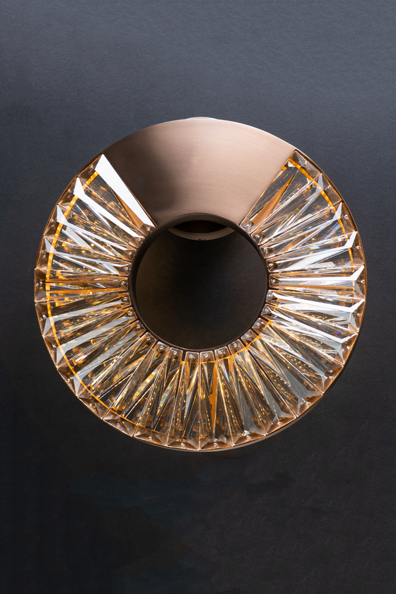 An elegant bronze LED round wall sconce with a crystal glass shade, designed to be mounted on a wall, suitable for indoor use.