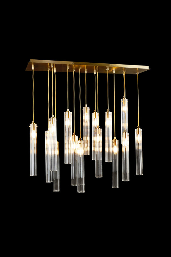 A contemporary glass chandelier with a satin brass finish, featuring multiple clear glass pendants hanging at different lengths.