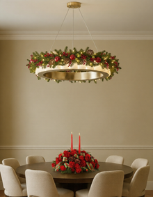  Decorative alabaster satin brass chandelier with Christmas wreath and table centerpiece in a room.