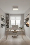Modern home office with a desk, computer, and decor and white LED square ceiling light.