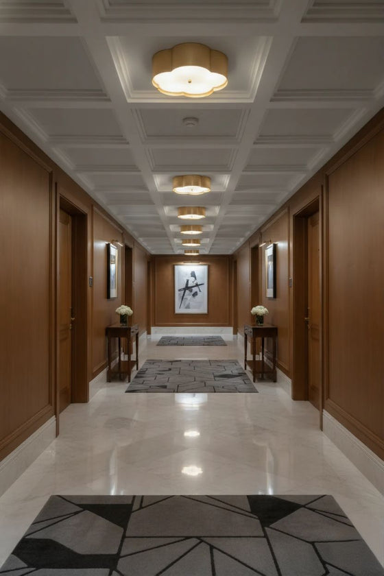 Luxurious hallway with wooden walls, a satin brass metal ceiling light fixture, and decorative elements.