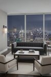 Modern living room with a city skyline view at night. Matte Black with white glass sconce.