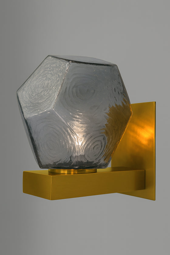 Hexagonal glass light fixture with satin brass base with smoke glass on a gray background