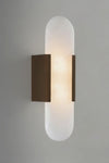 Wall-mounted bronze and alabaster light fixture with a cylindrical glass shade on a gray background