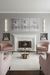 Living room with pink chairs, a fireplace, and ballet-themed decor. Alabaster satin brass LED wall sconces.