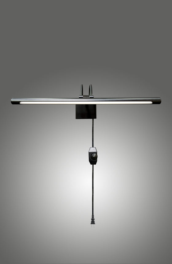 Modern LED matte black sconce plug-in or hardwire light fixture on a gray background