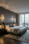 Modern bedroom with gray walls, a large bed, and large windows. LED Crystal sconce.
