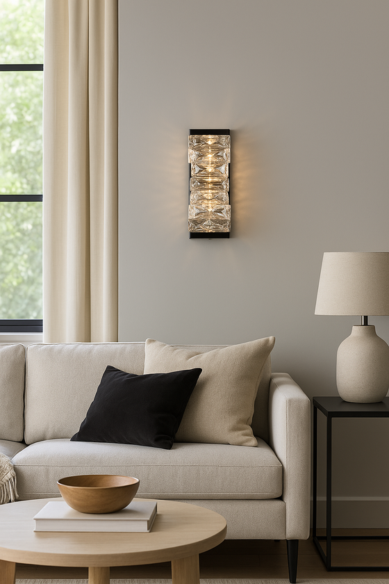 Modern living room with beige sofa, coffee table, and black chrome LED crystal wall sconce.