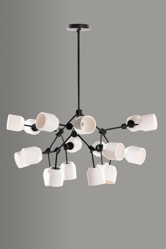 Modern matte black LED chandelier with white lampshades on a gray background