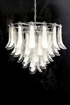 Chandelier with silver finish and clear and white glass shades on a black background