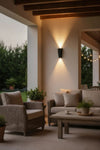 Outdoor patio area with furniture and wall lighting