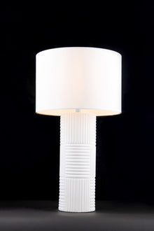  A sleek modern table lamp with a white ceramic base and a white fabric shade, featuring a dimmer switch on a black cord.
