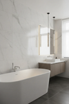 Terrazzo pendant Modern bathroom with a freestanding bathtub, sink, and mirror.