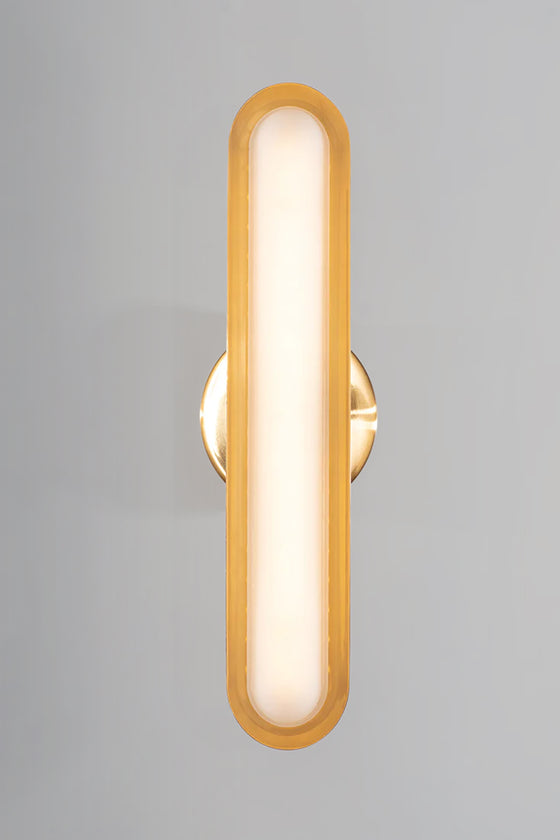 satin brass wall sconce Wall-mounted light fixture with a gold frame and white interior on a gray background