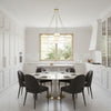 Orion Chandelier Modern kitchen with a dining table and chairs in a bright, white interior.
