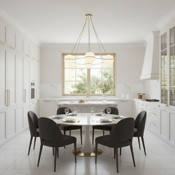 Orion Chandelier Modern kitchen with a dining table and chairs in a bright, white interior.