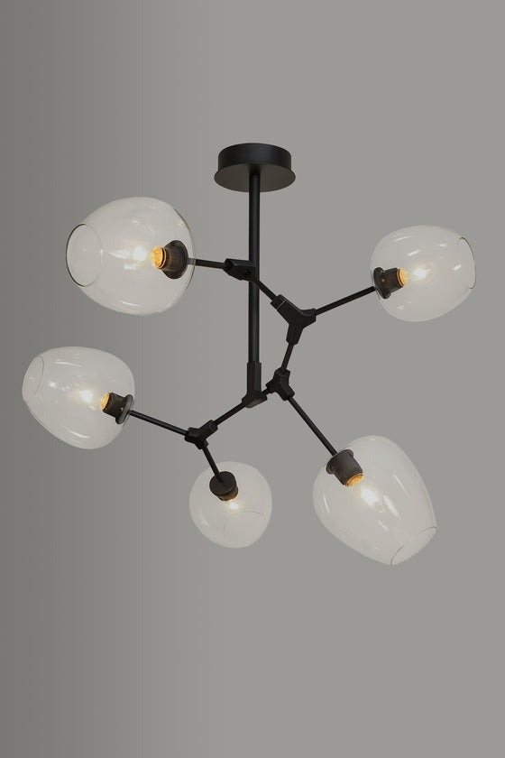 Modern chandelier with black metal frame and glass shades on a gray background