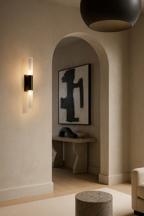 Modern interior with black wall sconce, abstract art, and minimal decor.