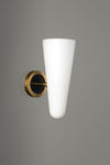Wall-mounted light fixture with white cone-shaped shade and gold base on a gray background