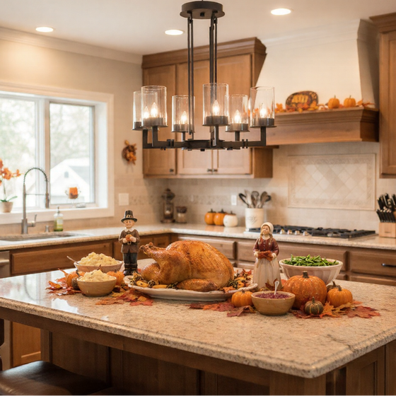 Decorative Thanksgiving scene in a kitchen with roasted turkey and pumpkins on a island. Matte black with clear chandelier pendant.