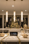 New Year's Eve celebration setup with a table, clock, and decorative items. Alabaster satin brass pendant.