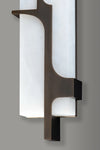 Modern wall-mounted light fixture with white glass and bronze metal on a gray background