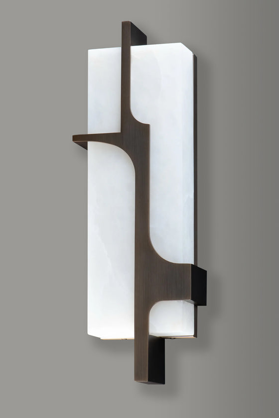 Modern wall sconce with white glass and bronze metal frame on a gray background