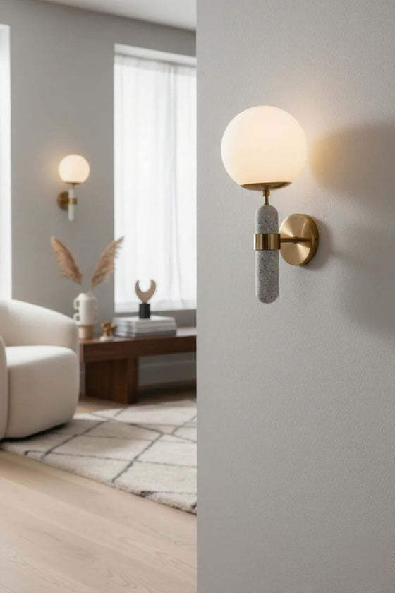Modern wall satin brass sconces in a living room setting with neutral tones.