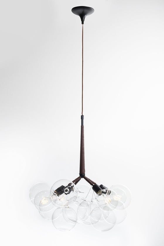 A contemporary industrial kitchen matte black light featuring a bouquet of clear glass globes hanging from the ceiling.