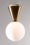 A ceiling light fixture with a frosted white globe shade and a brass finish base.
