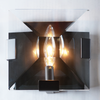 Close up view of the Ann Arbour Glass Wall Sconce, highlighting the light from the fixture
