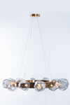 A contemporary geometric glass chandelier with a satin brass finish, featuring clear glass geometric shapes.