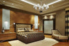 Fairmont Chrome Chandelier with Ribbed Glass Arm shown above a bed in a master bedroom setting