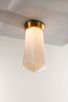 A LED ceiling light fixture with a geometric shape and a matte opal glass shade, featuring a satin brass finish.