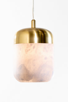  A LED pendant light with a satin brass finish and an alabaster shade, hanging from a chain.