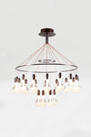 A satin bronze LED contemporary chandelier with clear glass shades and bronze-colored metal pendants.