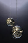 Two bubble-shaped pendant light fixtures with a metallic plated mirror shade, suspended by cords from a matching metallic canopy, displayed against a dark background.