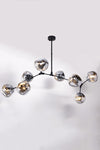 A contemporary chandelier with a matte black frame and eight chrome-plated oblong glass bubbles, designed to resemble a sputnik structure.
