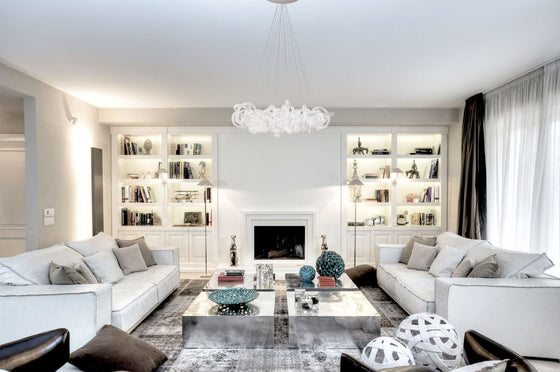 Loren Clear Rope Glass Chandelier shown installed in a living room setting over a large coffee table