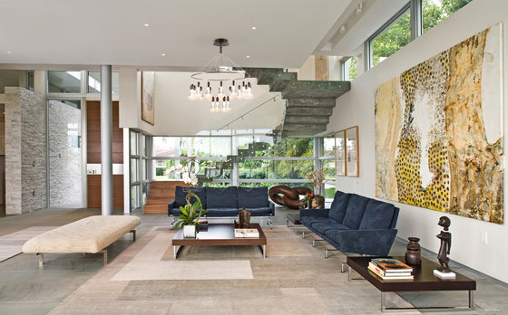 Madeira Satin Bronze Contemporary Chandelier installed in a living room setting over a coffee table 