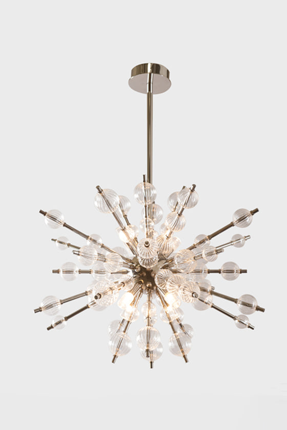 A modern mid-century style starburst glass balls chandelier with polished nickel finish and LED lighting.