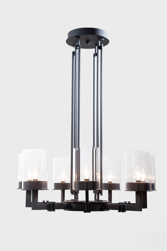A round matte black chandelier with clear glass shades, featuring adjustable stems and LED lighting.